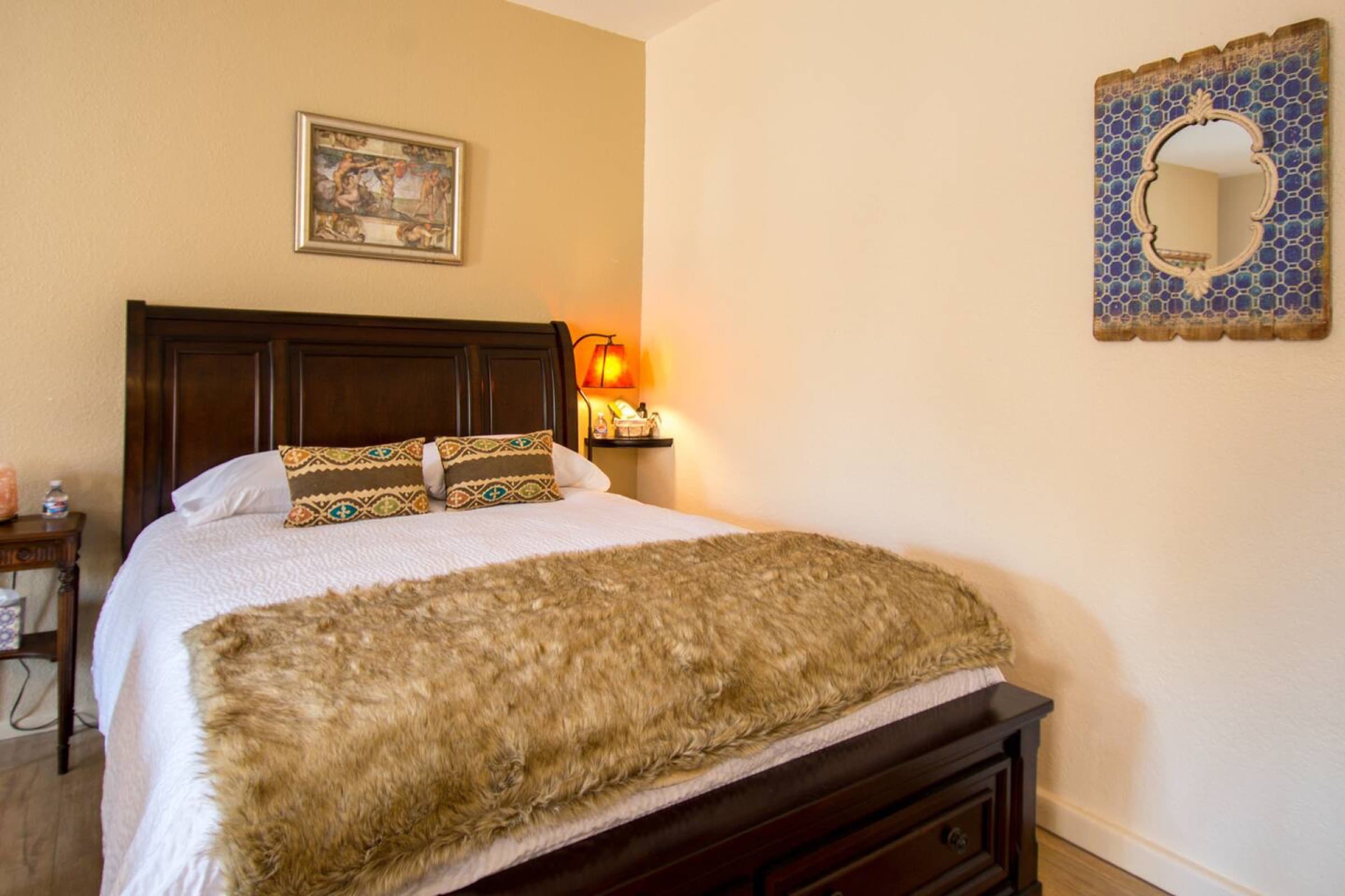 Queen bed with nightstand and flowers